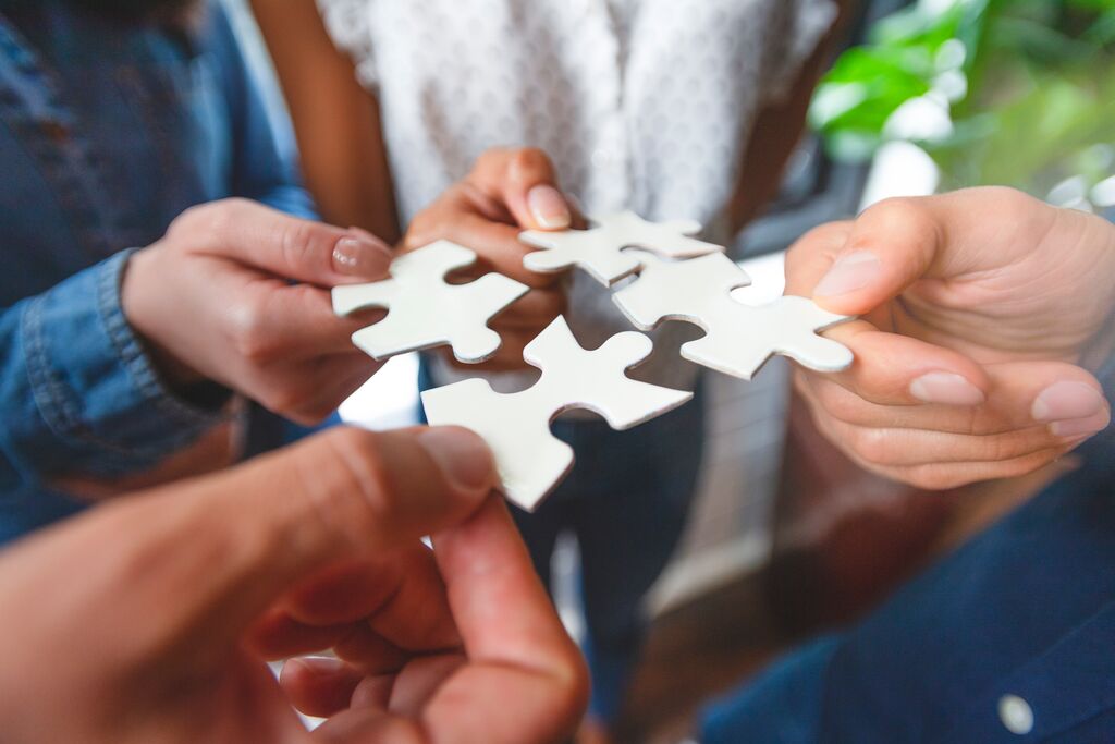 Group of business people holding a jigsaw puzzle pieces