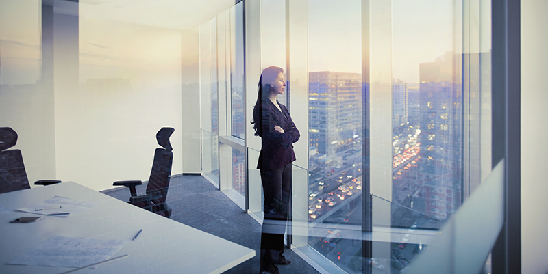 Businesswoman looking out window in meeting room
