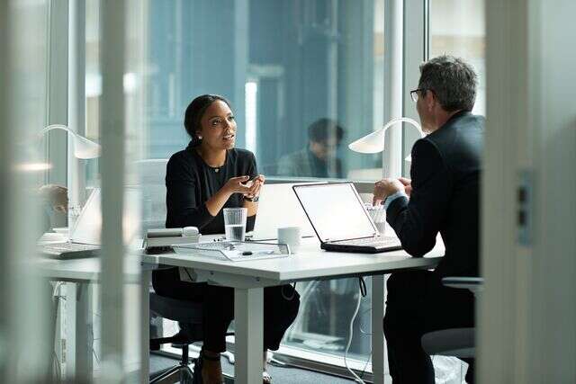 Businesswoman speaking with co worker in open office