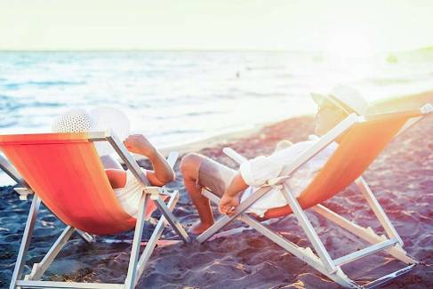 men and women sitting in the beach