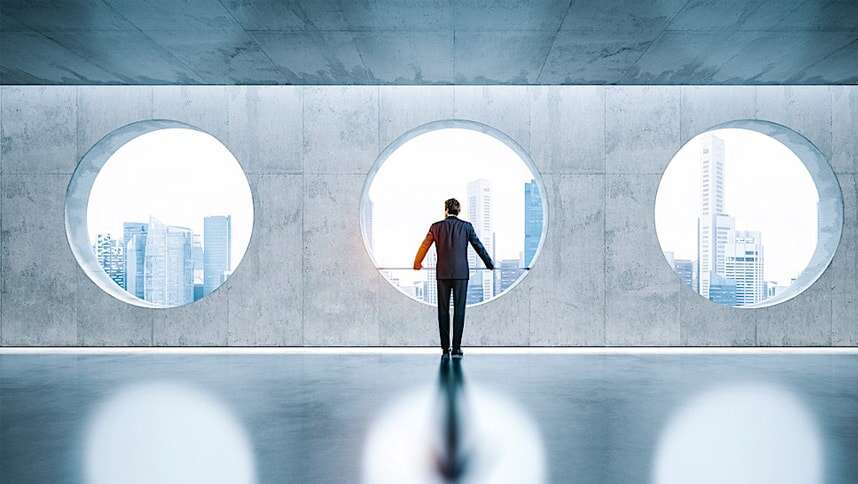 busineness man looking the city through window