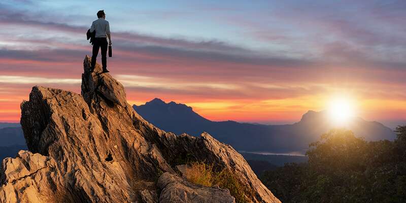 shutterstock_Man Standing In Top of the Hill