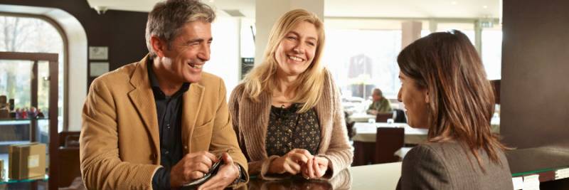 Senior Couple Checking into a Hotel