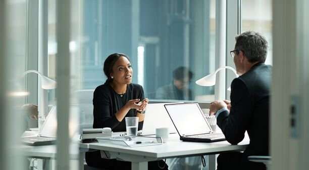 Businesswoman speaking with co worker in open office