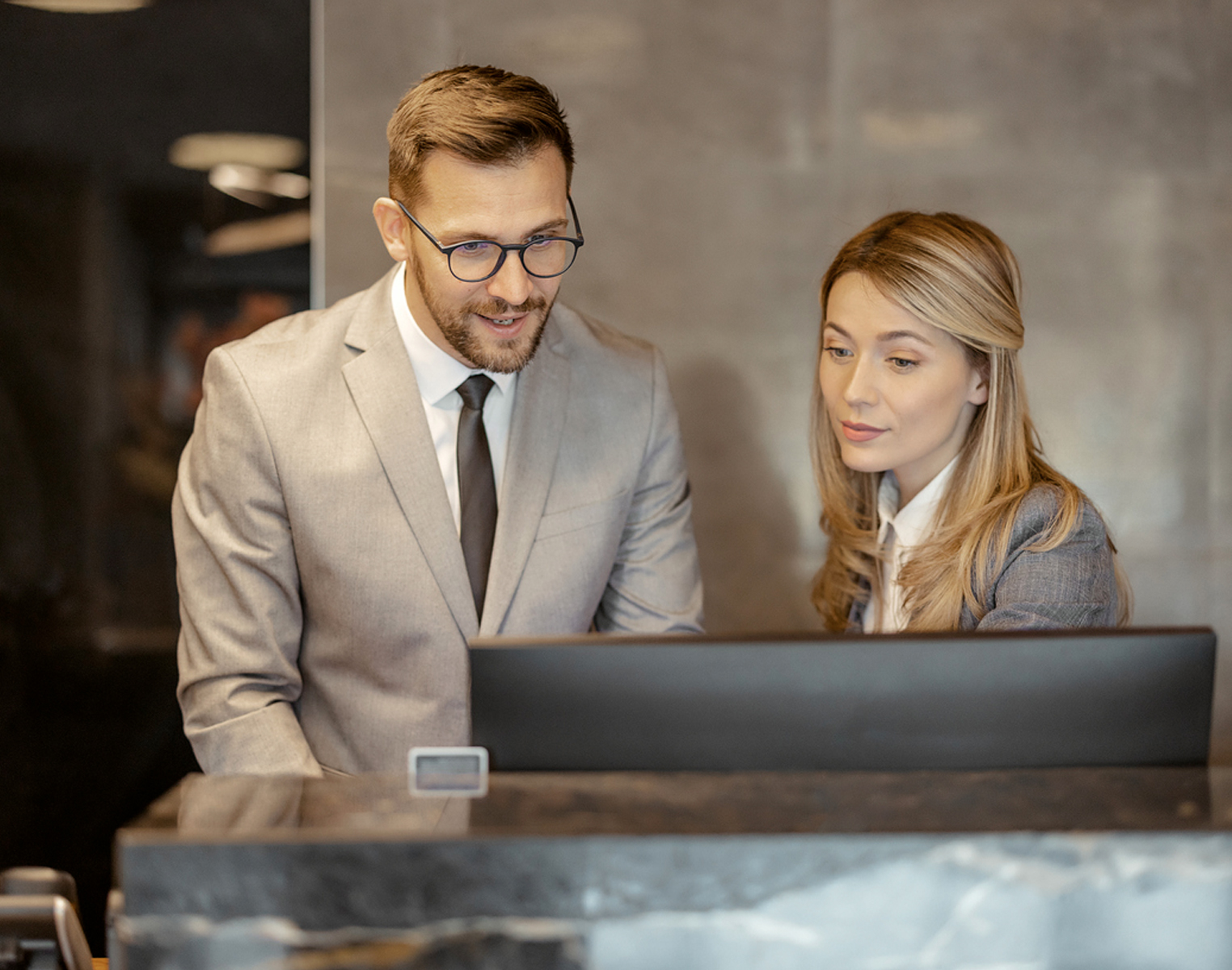 woman and man looking at screen