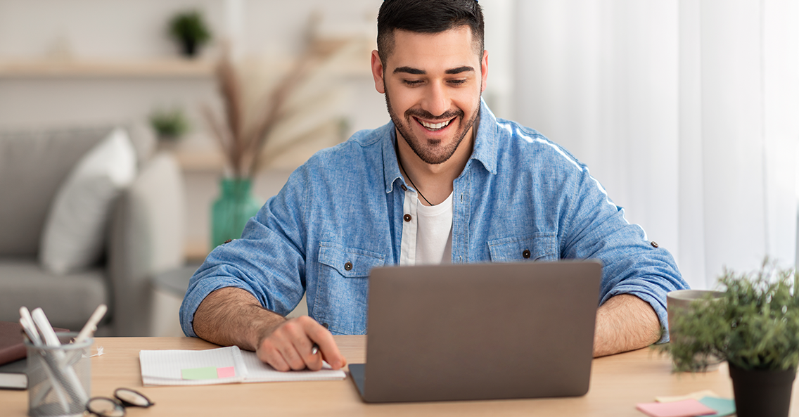 Male watching webinar looking at pc screen working or studying remotely (1)