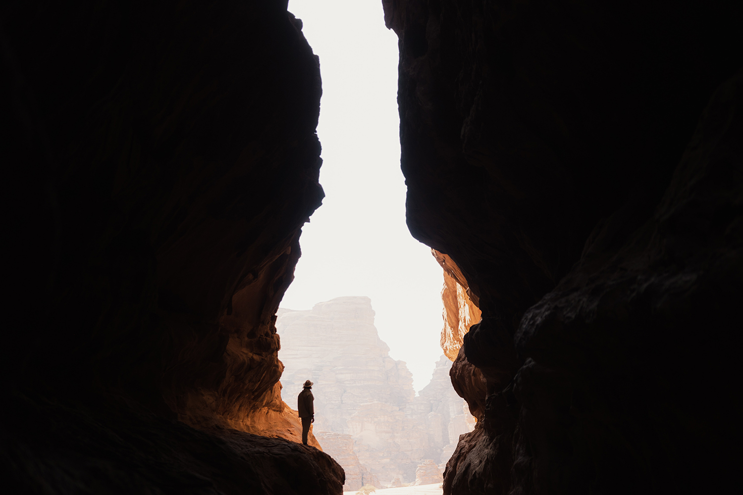 A person standing in the middle of a cave