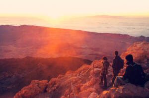 a group of people standing on a rocky mountain