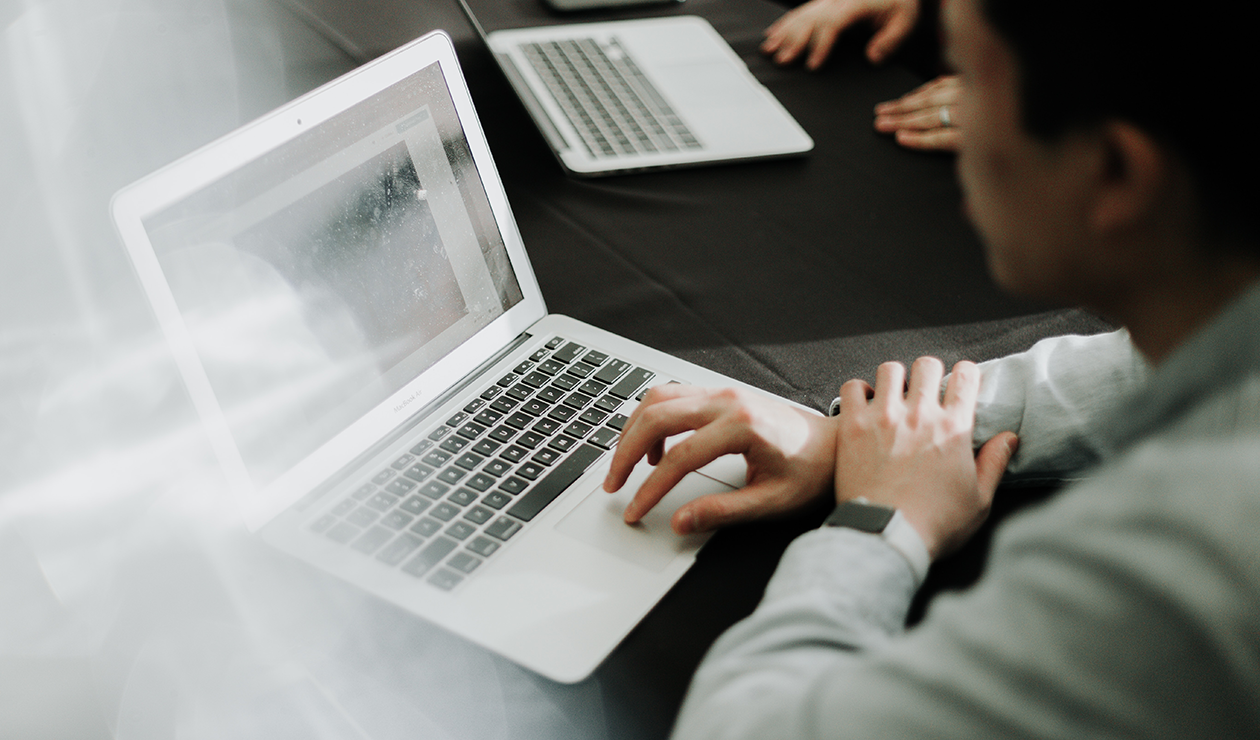 man sitting in front of a laptop computer