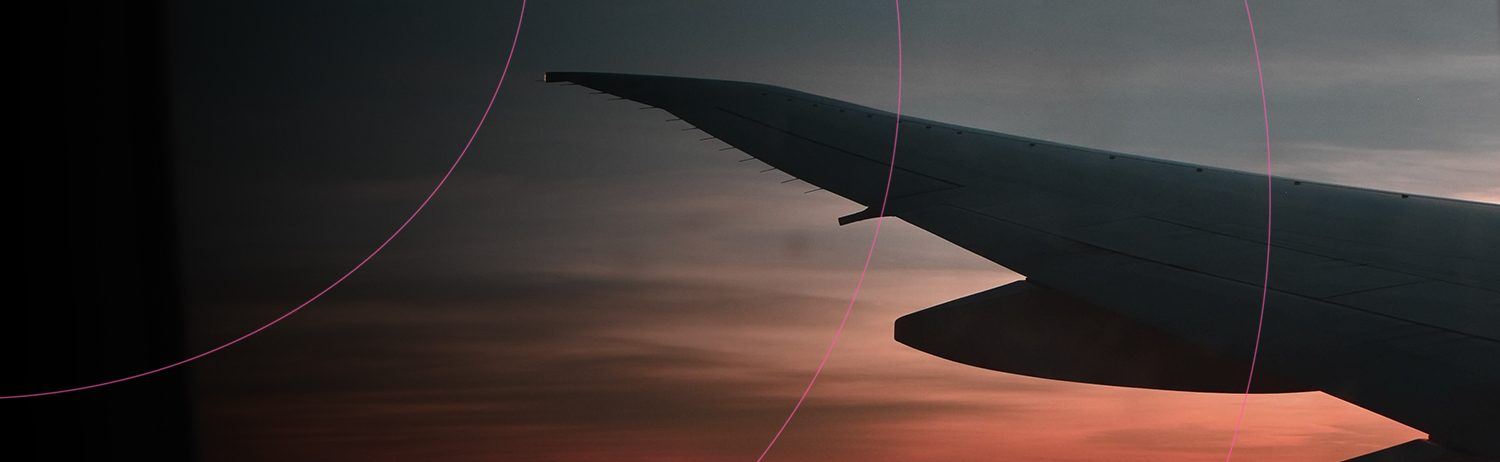A plane wing in the sky at dusk